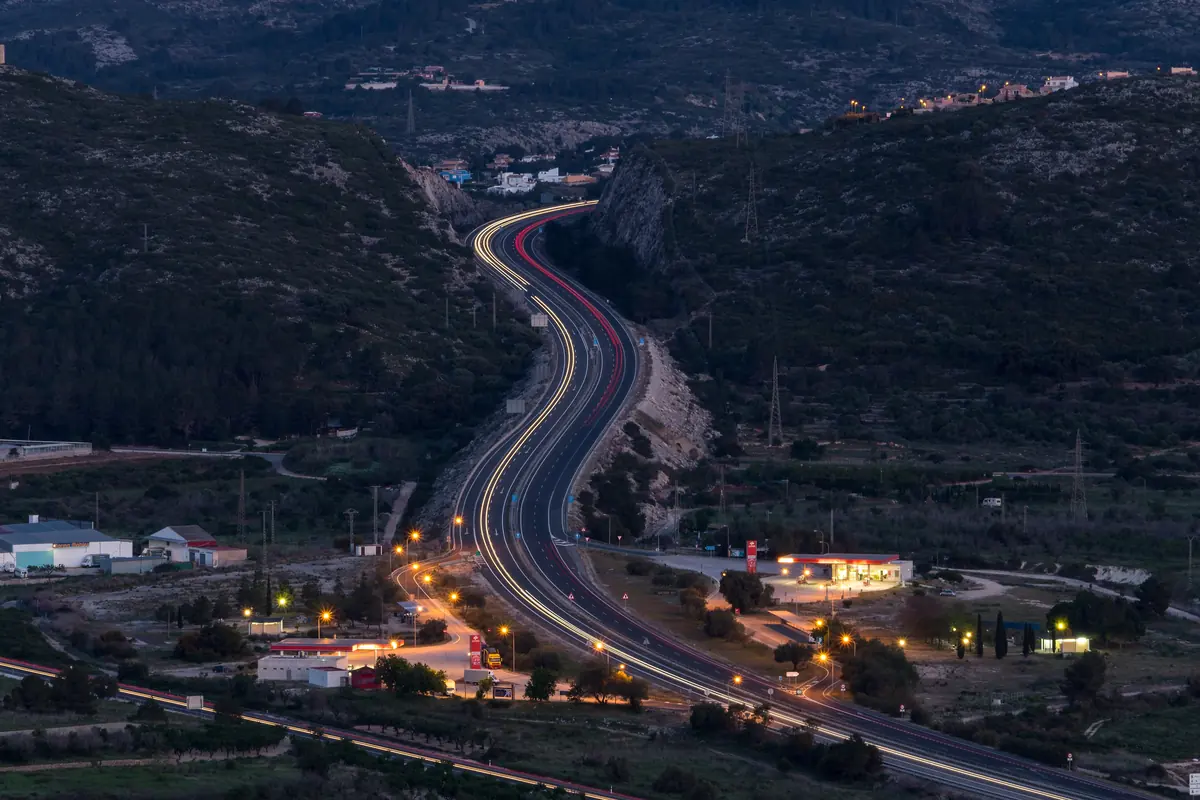The AP-7 motorway winding through the hills near Dénia at dusk
